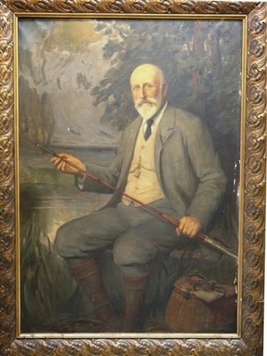John Henry Amshewitz R.B.A. (1882-1942): Portrait study of Frederick M. Halford seated within a wooded river landscape beside a wicker creel and holding an inlaid handle trout fly rod, oil on canvas, signed to lower left corner and dated ’07, in large gil