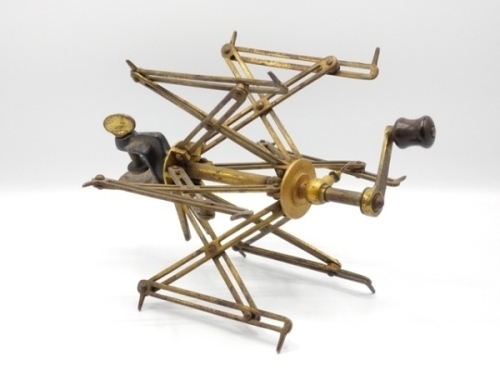 F.M.H.’s Farlow 1st model Sextile line winder, fitted six collapsible slotted brass arms, turned ebonite winding handle on straight crank arm and iron “G" clamp table fitting with brass thumb locking screw and twin drop locking arms, crank arm stamped mak