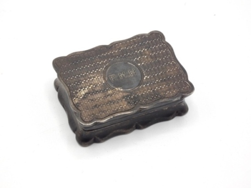 F.M.H.’s silver snuff box, the rectangular lidded box with scalloped edge, engine turned decoration and central circular cartouche block engraved “F.M.H." , silver gilt interior and (rather amusingly) used by F.M.H. as a small receptacle for carrying fly 