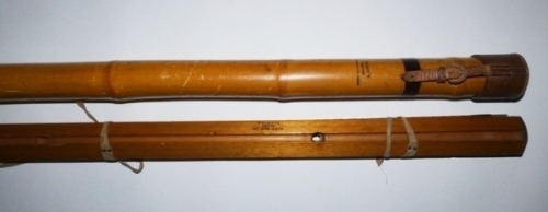 A Hardy bamboo and leather capped rod tube, the 40" long tube with strap locking cap and ink stamped makers details and a Hardy wooden trout rod former, recessed to take four rod sections for a 9’6" rod (one Hardy “Halford" rod tip still held in former),