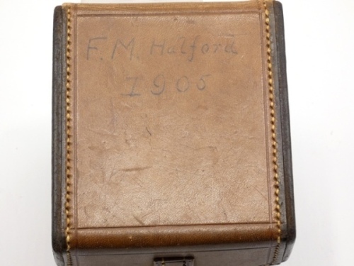 A Hardy block leather trout reel case, lid ink inscribed F.M. Halford 1905, to take a 3 3/8" reel, red velvet lined interior and leather locking strap, one side panel with applied paper label ink inscribed “Cecil" (F.M.H.’s grandson) and holding an un-n