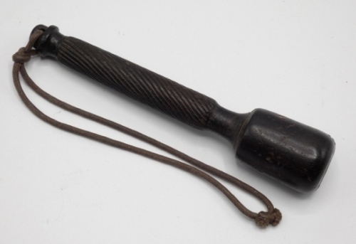 F.M.H.’s turned lignum vitae trout priest, weighted knop head, open spiral turn decorated shaft, loop finial with original leather wrist lanyard, 5" long, circa 1880