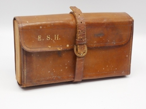 A leather cased coarse fishing compendium, outer case gilt stamped E.S.H. (Ernest Halford), interior holding a treen and bone spindled float and line winder with lidded central shot and cap compartments, and fitted end pouch pocket, float/tool loops and p