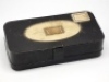 F.M.H.’s black japanned rectangular mayfly box, cream painted interior fitted twelve lidded compartments, each with drop ring handle, outer case with oval cream painted central panel and clip lock, probably made by Malloch’s of Perth and pre-dating the Ha