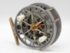 A fine Chris Lythe Float Master 4" centre pin reel, anodised pewter finish, 1" wide caged and six spoked drum with twin ivorine handles, double ventilated flanges and twin release regulator forks, B.P. line guide, brass stancheon foot, rear sliding brass