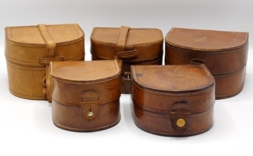 Five “Aerial" block leather cases three of the D shaped cases to take 4 1/2" models and one for a 4" and one a 3" reel, various styles, all with velvet lined interiors, strap or tab fasteners and one gilt stamped Carter & Co. details (5)