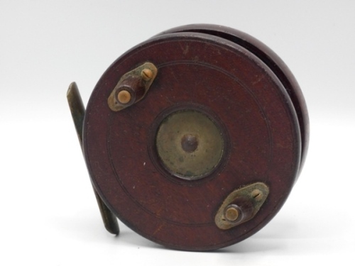 An unusual Nottingham 4" walnut centre pin reel, solid drum with twin tapered treen handles and white metal spindle plate, brass starback foot with most unusual “faux" optional check button drum release lever and spear point finials, with additional fini