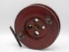 An Allcock Badminton style 7" Scarboro sea centre pin reel, the mahogany shallow cored drum with twin bulbous cow horn handles, recessed spindle well with four ventilation ports and brass wing locking nut, brass stancheon foot, stamped oval logo, circa 19