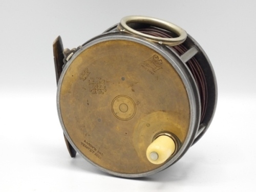 A scarce Hardy Brass Faced Perfect 4 1/4" salmon fly reel with engraved coronet and monogram, reel with domed ivorine handle, fixed nickel silver line guide, brass strapped rim tension screw with Turk’s head locking nut and early calliper spring check me