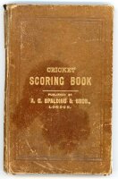 'Cricket Scoring Book' 1914-1935. A scorebook published by A.G. Spalding & Bros., London, comprising handwritten scores in pencil for the period, assumed to have been compiled by a cricket follower. The book bound in original brown boards with gilt title 