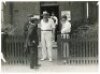 W.G. Grace. Two original mono candid style photographs of Grace appearing for a match played at Twickenham, probably 1908. Both photographs depict Grace in cricket attire and straw hat. In one Grace is exiting the Church Institute with other players and, - 2