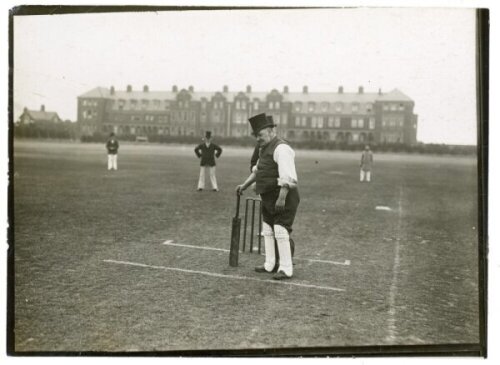 'Veteran cricketers play in top hats at Yarmouth'. Two early original mono photographs apparently depicting a novelty cricket match, the players wearing top hats. Inscriptions in pencil to the verso describe 'Billy Ellis, who is over eighty taking guard',