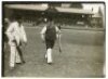 'Veteran cricketers play in top hats at Yarmouth'. Two early original mono photographs apparently depicting a novelty cricket match, the players wearing top hats. Inscriptions in pencil to the verso describe 'Billy Ellis, who is over eighty taking guard', - 2