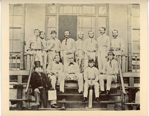 Parr's XI to Australia 1863/64. An early mono photograph of the twelve members of the second touring party to Australia. Players are depicted on the steps of the Lord's pavilion wearing cricket attire, and include Parr, Mortlock, E.M. Grace, H.H. Stephens