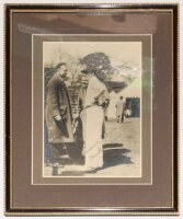 Don Bradman. Original 1930s mono photograph of Bradman wearing cricket attire and Australia cap, standing in conversation with two gentlemen, a marquee in the background. Very nicely signed in black ink to the photograph, 'Sincerely yours, Don Bradman'. P