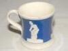 Staffordshire blue ground waisted cricket mug with strap handle and beaded rim. With three relief moulded figures of a batsman, bowler and wicket keeper in cream, believed to be Lillywhite, Pilch and Box. c1860. Two minor chips to rim otherwise in good co - 3