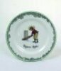 'There's Style'. A Royal Doulton Black Boy dessert plate, entitled 'There's Style' printed with a boy in a white shirt, red waistcoat, yellow trousers and a floppy hat taking guard in front of the stumps with bat almost horizontal. Green floral decoration