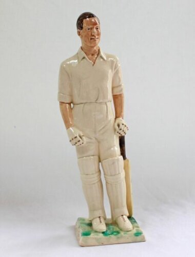 'Peter May' Surrey & England 1950-1963. A glazed pottery figure of Peter May standing in batting attire with bat to side. Incised signature of M. Mitchell Smith to back of base. 11.5" tall. Crack and old repair to bat handle, otherwise in good condition. 