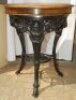 W.G. Grace. Original cast iron circular public house table with circular wooden top, supported by three leg moulded with portrait busts of Grace, with imprinted initials 'W.G' above, wearing cricket cap to top of each leg with decorated pierced apron of b