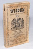 Wisden Cricketers' Almanack 1943. 80th edition. Original limp cloth covers. Only 5600 paper copies printed in this war year. Faded, worn and discoloured covers, signs of damp to covers and odd page extremities, internally odd faults, good - cricket