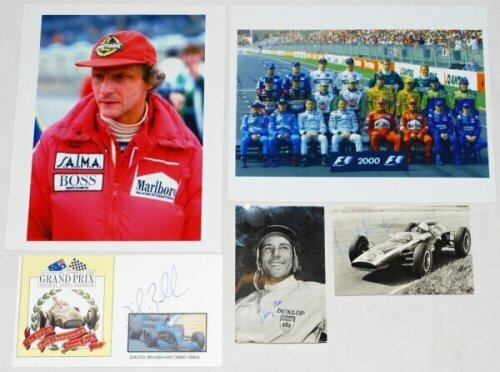 Motor racing. A selection of photographs and a commemorative cover, three signed including a small mono signed photograph of Stirling Moss, another dated to verso 10th January 1963 apparently signed by Bruce McLaren, and a commemorative cover for the 500t