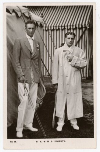 R.F. & H.L. Doherty. Rare original and early mono real photograph postcard of the brothers, Reginald 'Reggie' and Laurence 'Laurie' Doherty, standing full length holding rackets and wearing tennis attire, Reginald with a blazer, Laurie in a full length wh