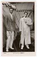 R.F. & H.L. Doherty. Rare original and early mono real photograph postcard of the brothers, Reginald 'Reggie' and Laurence 'Laurie' Doherty, standing full length holding rackets and wearing tennis attire, Reginald with a blazer, Laurie in a full length wh