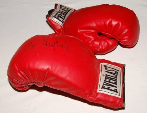 Henry Cooper. 'Everlast' red boxing glove signed in black pen by Cooper. Sold with an unsigned red Everlast boxing glove, and a mono photograph of Cooper holding two Championship belts, signed by Cooper. 5"x7". Qty 3. VG - boxing