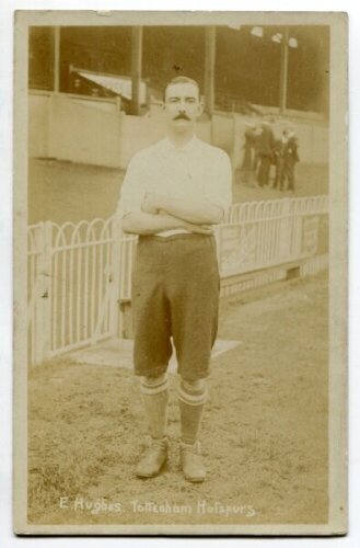 Edward Hughes. Tottenham Hotspur 1899-1908. Early sepia real photograph postcard of Hughes, full length in front of the stand, in Spurs attire. Title to lower border 'E. Hughes. Tottenham Hotspurs'. Jones Bros of Tottenham Postally unused. Some light fadi