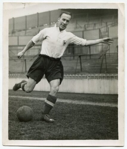 Albert Henry Gibbons. Tottenham Hotspur 1937-1938 and 1940-1946. Mono real photograph of Gibbons, full length, in Spurs attire kicking the ball. Photograph by Dailypress Photographic Agency, with stamp to back. 5"x6". Very minor nick to top edge of the ph