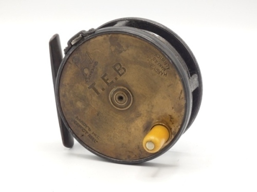 A scarce Hardy Brass Faced Perfect 3 1/8" trout fly reel and block leather case, ivorine handle, brass foot, strapped rim tension screw and early calliper spring check mechanism, contracted drum with four rim cusps and milled nickel silver locking screw,