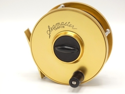A fine Seamaster Tarpon 4" anti-reverse saltwater fly reel, gold anodised finish, second right hand wind model with composition handle, central spindle mounted tension adjuster, block foot, triple stainless steel drum pillars, little used condition and i