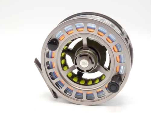 A fine Sage Spectrum Max 10/12 saltwater big game fly reel and spare spool, large arbour model with silver anodised finish, counter-balanced handle, skeletal frame, milled drum locking nut and rear graduated spindle mounted tension adjuster, as new condit
