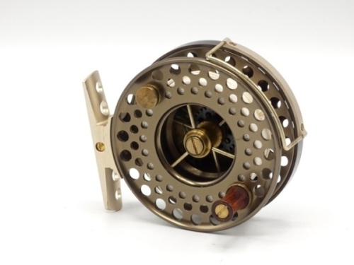A good J. Austin Forbes 3" trout fly, bronze anodised finish, multi-perforated three spoked drum with counter-balanced rosewood handle, pierced foot, rear milled brass tension adjuster, only very light signs of use, in original leather pouch and card box