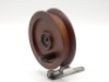 A scarce Milward's Brownie 3 ½" turn table casting reel, turned mahogany drum with spring locking reversible ebonite handle mounted on swivelling alloy foot with nickel silver wire pig-tail line pick-up, drum stamped make and model detail, circa 1922 (s