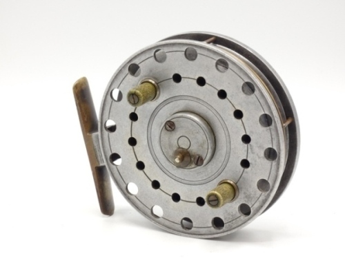 An Allcock's Improved Homer Flick 'Em 4 1/8" centre pin reel, shallow cored drum with twin xylonite handles and raised spindle cover with spring release latch, brass annular wire line guide and stancheon foot, backplate stamped model details, 1920's