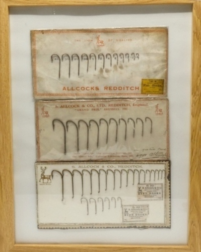 A framed display of three Allcock trade cards of hooks, various hook models including Kirby and Improved Pattern Down Eyed, 45 hooks in total, varying graduating sizes with ink details and on printed trade cards, 18" x 14" overall