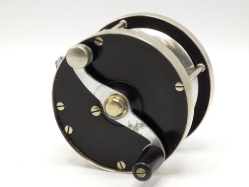 A rare Otto Zwarg Laurentian 2/0 multiplying salmon fly reel, ebonite and nickel silver construction, 2:1 ratio retrieve, counter-balanced handle on serpentine crank handle set within an anti-foul rim, triple nickel silver pillars (two double roller), p