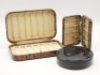 An un-named Neroda No.6 bakelite Drywet trout fly box, tortoiseshell finish, interior fitted chenille bars, a similar waistcoat trout fly box and a Hardy Album bakelite circular cast case, screw top lid embossed with fly cast decoration, 1940's (3) - 2