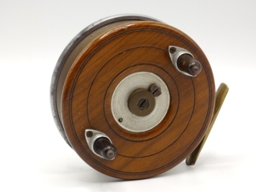A very rare Allcock Brigald 4" centre pin trotting reel, alloy backed walnut drum with twin composition handles on alloy cups, central milled brass patent spindle tension adjusting nut, brass star back foot with sliding optional check button and calliper