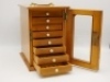 A rectangular pine salmon fly reservoir, fitted eight sliding drawers each with ivorine bun handle and fitted bars of nickel silver spring fly clips on ivorine plates, glazed door and brass swing carry handle, 9 ¾" x 9 ½" x 6 ½" overall - 2