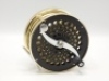 A fine Saracione Mk.IV Alta 4 ¾" salmon fly reel, left hand wind model with black /gold anodised finish, counter-balanced serpentine crank handle, alloy foot, multi-perforated drum and face plate, rear sliding optional check button and spindle mounted mil