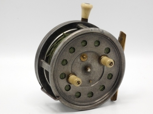 A scarce J.S. Sharpe Silex style 4" alloy bait casting reel, shallow cored drum with twin ivorine handles and spring release latch, brass foot, ivorine rim mounted casting trigger, Easicast type hinged wire brake control lever and strapped milled tensio