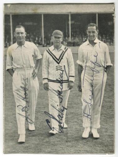 ‘The Century Makers’. 1928. Official mono printed newspaper picture, laid down to card, of Hobbs, Hendren and Sutcliffe walking off the pitch at Kennington Oval after they had each completed centuries, scoring a total of 463 out of 603 for 8 for ‘The Rest