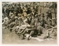 Australian tour to England 1921. Three original mono press photographs from the 1921 tour. Images including an excellent view of smiling spectators seated and standing at the boundary edge, many with improvised sun shades tucked in to their hats and caps,