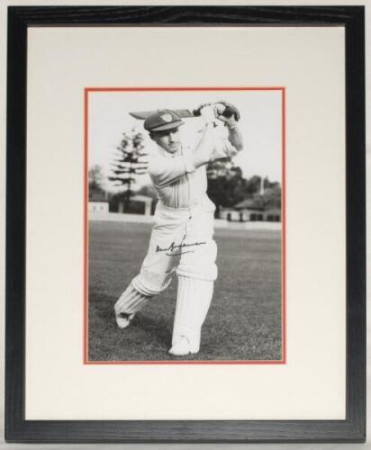 Don Bradman. Mono copy photograph of Bradman in batting pose, signed in later years to the photograph by Bradman. Approx. 12”x9”. Mounted, framed and glazed, overall 14.5”x18”. VG