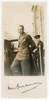 Don Bradman. Mono candid photograph of Bradman getting in to a car, signed to the lower border in ink by Bradman. A nice signature. Adhesive marks to verso, otherwise in very good condition. Sold with a near perfect first edition copy of ‘Don Bradman. Far