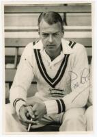 Ian Peebles, Middlesex. Good mono press photograph of a moody looking Peebles sat on a bench wearing Middlesex sweater and smoking. Signed in ink by Peebles. Central Press Photos, London. 4”x6”. VG