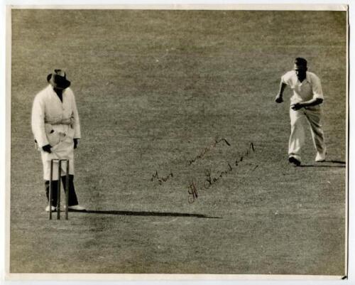 Harold Larwood. Excellent press photograph of Larwood running in to bowl for Nottinghamshire v Surrey 1935. Nicely signed in ink by Larwood ‘Yours sincerely..., very slight fading to inscription and signature. The photograph measures 10”x8”. G