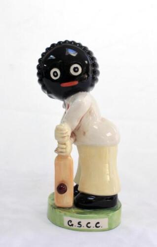 ‘The Golly Cricketer’. Large handpainted ceramic figure of a golliwog batsman made by Carlton Ware. To the front of the base there are the intials ‘G.S.C.C.’ standing for Golden Shred Cricket Club. This figure was not made for general release and was a on